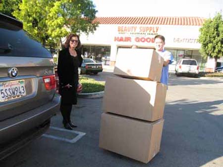 Melanie McFarland and Arnold unloads the next batch of boxes.