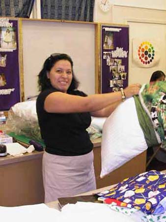TM Club President helps with the stuffing of pillows.