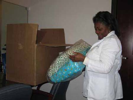 Facility Adminstrator of dialysis center takes a sneak peek of the fabulous pillowcases made‚ “Thank You!”
