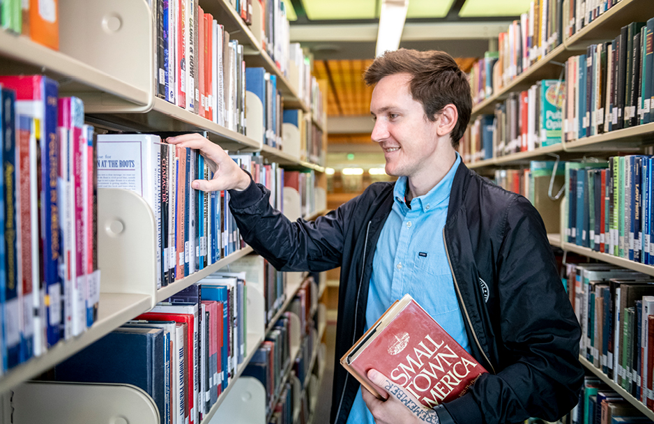 Student browsing library stacks