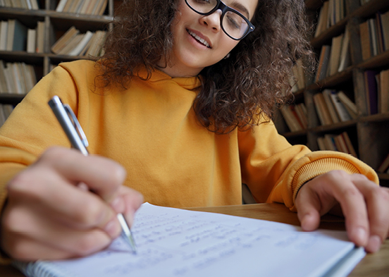 Woman writing on a notepad