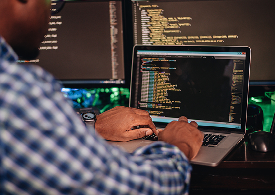 Person working on laptop with coding on it