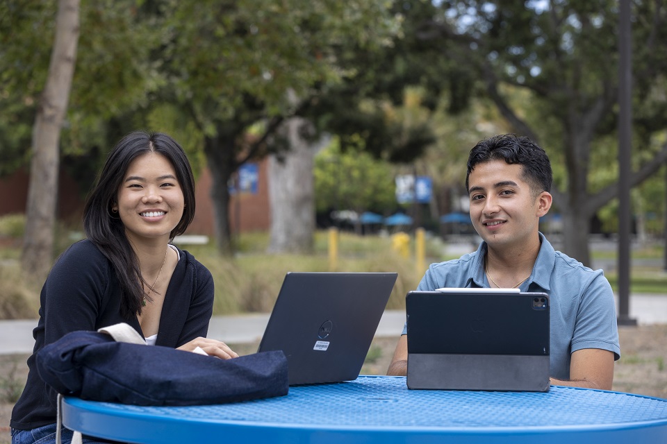 Two student ambassadors each on a laptop ready to help students at the virtual info desk.