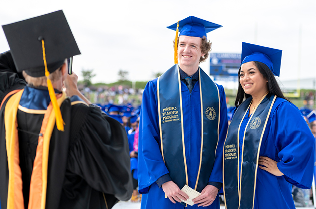 Graduates smiling at commencement