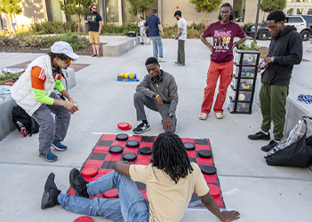 Students playing giant checkers game in a group