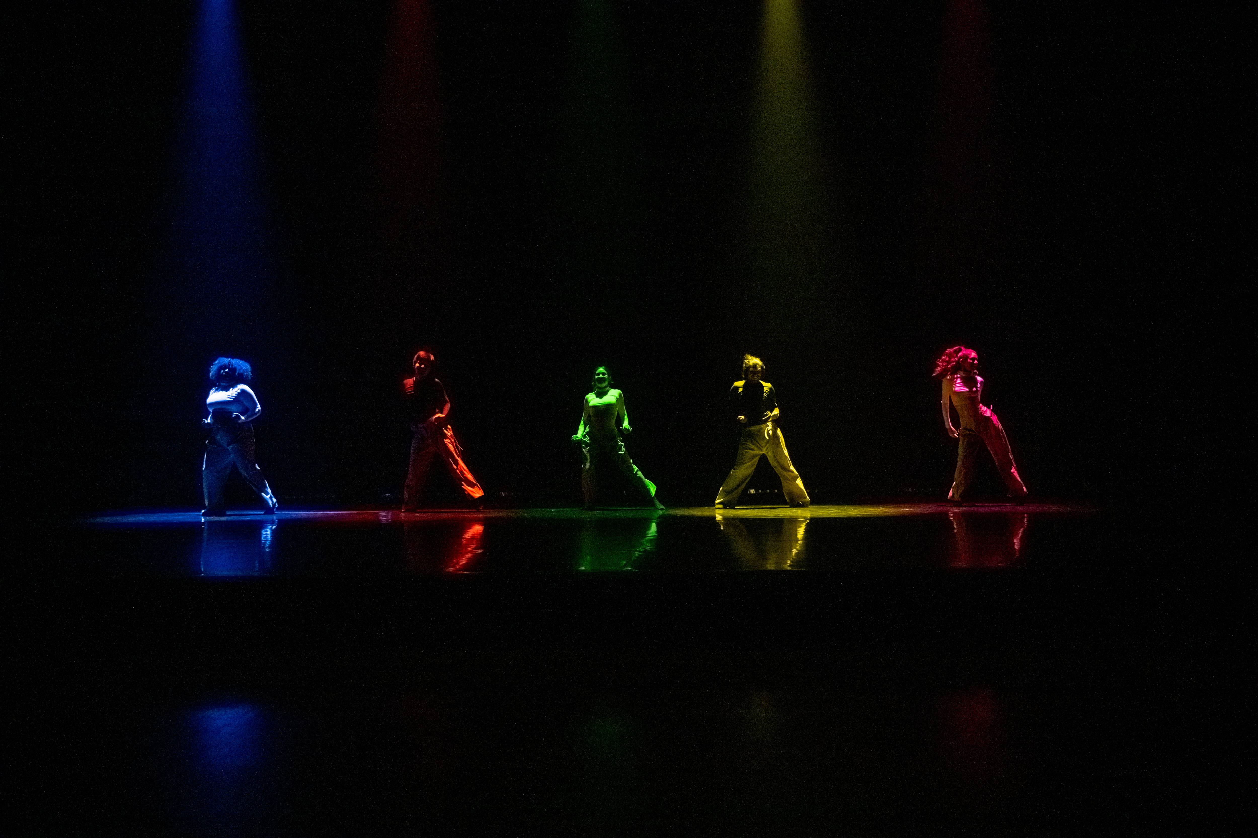 Five dancers on a stage.