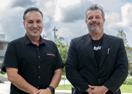 El Camino College real estate professor John Yeressian (left) and student William Wilson (right) pose outside of the ECC Library for their ElCo Chats podcast episode.