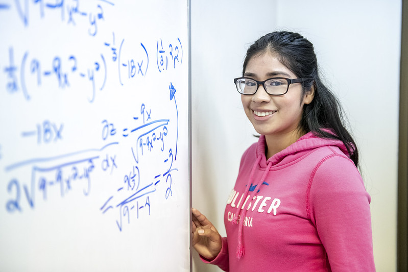 Student standing at dry erase board