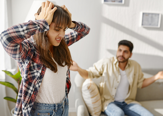 Angry woman with man in background