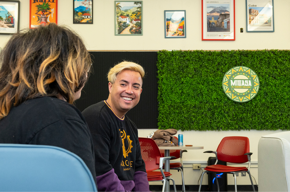 Student smiling with the MICASA logo in the background.