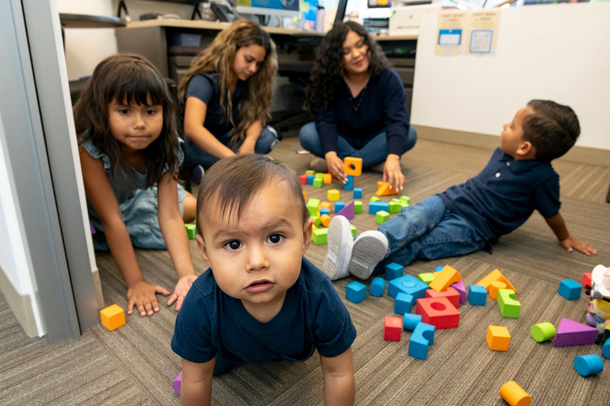 Child looking at camera while kids playing in background