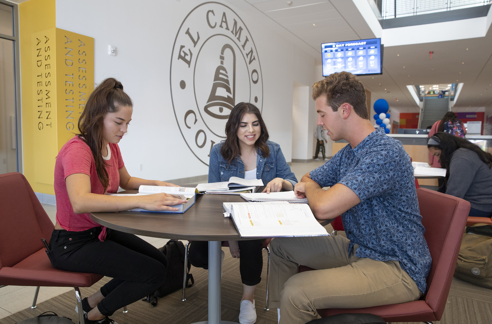 Group of three students studying around a table